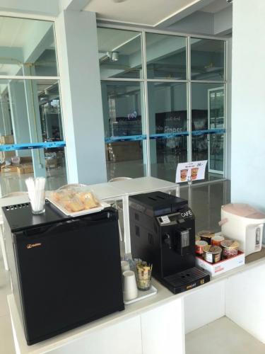 a kitchen with a counter with a coffee maker at A Hotel Cozy in Ban Pa Sak