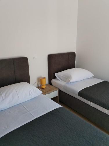 two beds sitting next to each other in a room at Adriatica in Zadar
