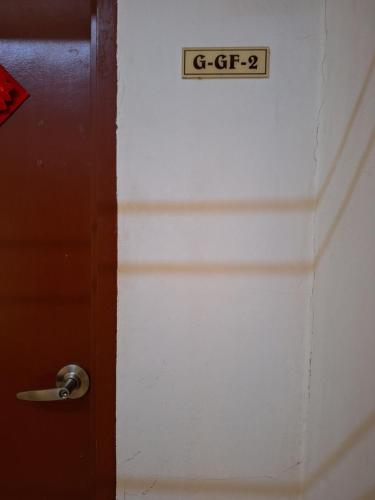 a door with a sign that reads g tf at Gillian's Home in Kampong Rampayan