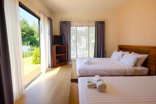 Postel nebo postele na pokoji v ubytování Rakmak Kan Resort & Cafe