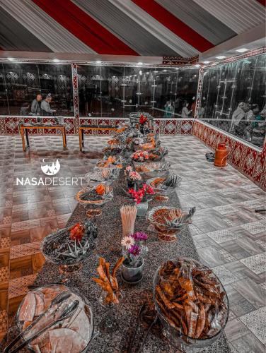 a long table with plates of food on it at Nasa desert luxury camp in Wadi Rum