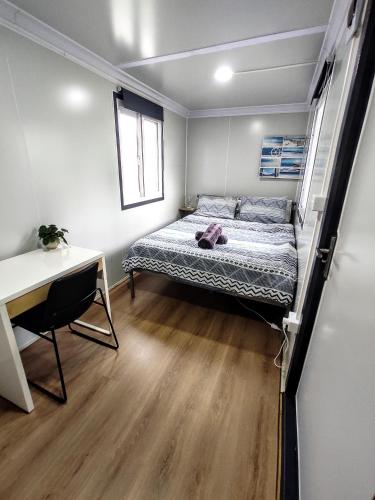 a bedroom with a bed and a desk in it at Tiny Home Sunset Boulevard in Melbourne