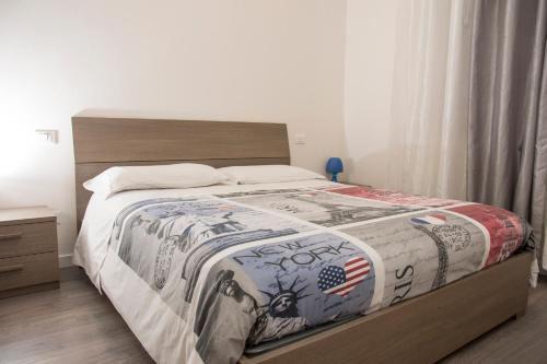 a bedroom with a bed with a blanket on it at casa vacanza dovevai in Bergamo