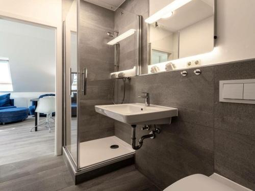 a bathroom with a sink and a mirror at Water Comfortable holiday residence in Ostseebad Koserow