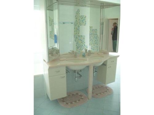 a bathroom with a sink and a mirror at Picobello 2 Comfortable holiday residence in Timmendorfer Strand