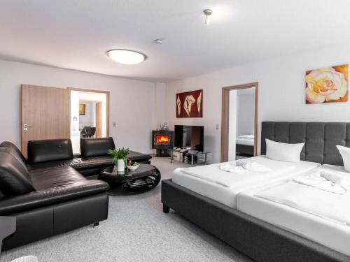 a bedroom with a large bed and a living room at Winter Comfortable holiday residence in Ostseebad Karlshagen