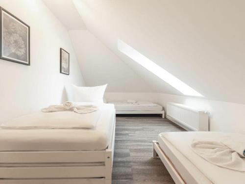 two beds in a room with a attic at Space Comfortable holiday residence in Ostseebad Koserow