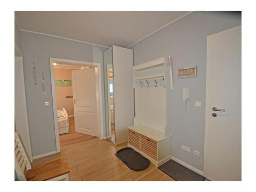 a room with a hallway with a desk and a door at Finn Comfortable holiday residence in Juliusruh