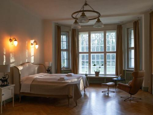 a bedroom with a bed and a large window at Villa Sommerfeld 
