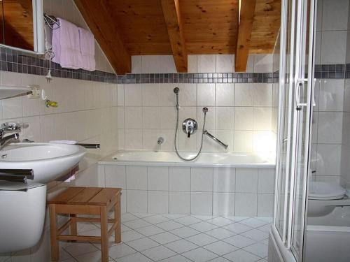 a bathroom with a shower and a tub and a sink at Klausenberg Hausberg - Gästehaus am Maibaum in Reit im Winkl