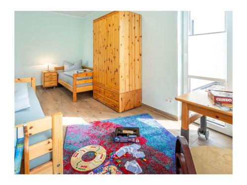 a room with a living room with a table and a room with a couch at Three-master house no 3 in Breege