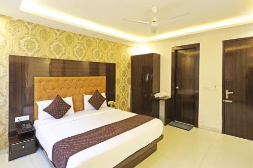 a bedroom with a large bed in a room at HOTEL ICONIC At Delhi International Airport in New Delhi