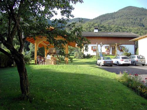 a gazebo in a yard with cars parked at 1 - House Rosenegger in Staudach-Egerndach