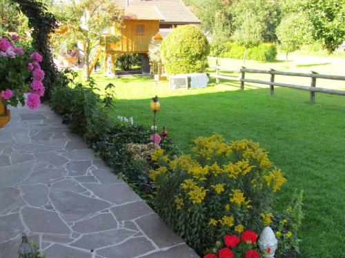 a garden with colorful flowers and a path at 1 - House Rosenegger in Staudach-Egerndach