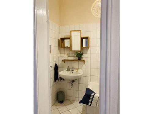 a small bathroom with a sink and a toilet at Roßplatz in the center in Leipzig