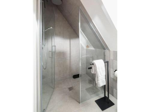 a bathroom with a shower with a glass door at Mooi 2 Comfortable holiday residence in Norderney