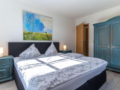 a bedroom with a large bed with two pillows at Luxury house R1 Comfortable holiday residence in Sankt Peter-Ording