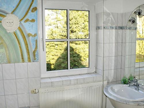 a bathroom with a sink and a window at Luxury house R2 with view in Sankt Peter-Ording