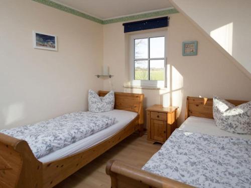 a bedroom with two beds and a window at Luxury house R2 with view in Sankt Peter-Ording