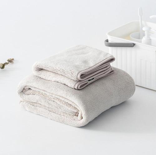 a stack of towels sitting on a counter next to a sink at yourcity 台北101 和 大巨dome旁邊 大空間睡8人 in Taipei