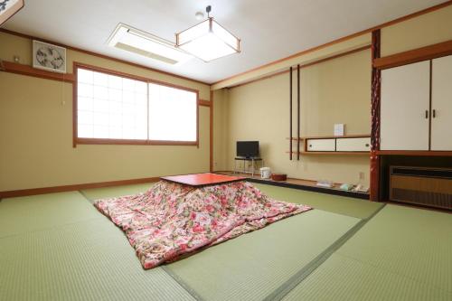a room with a rug laying on the floor at Ryokan Nakaya in Muraoka