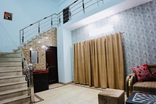 a living room with a staircase and a shower at BLISS STAYS in Rishīkesh