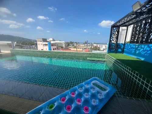 a swimming pool with a tray of water remotes at I AM O'TEL Patong in Patong Beach