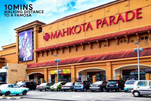 a large building with cars parked in front of it at Mahkota Timber Heaven 6pax Historical Spot Jonker in Melaka