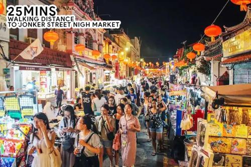 a crowd of people walking down a crowded street at night at Mahkota Timber Heaven 6pax Historical Spot Jonker in Melaka