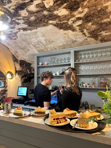 a man and woman sitting at a table with food at Amante Boutique in Kuressaare