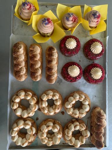 a box filled with different types of donuts and cupcakes at Amante Boutique in Kuressaare