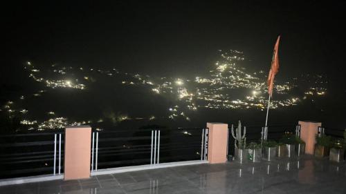 a view of a city lit up at night at Hotel Rudraksh in Gupta Kāshi