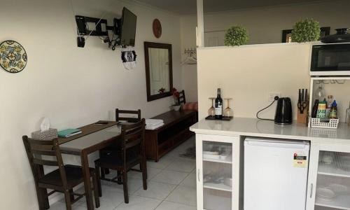 a kitchen with a table and a dining room at Papa Joe in Austins Ferry