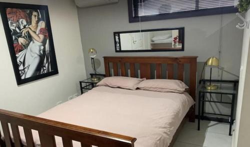 a bedroom with a bed and a picture on the wall at Papa Joe in Austins Ferry