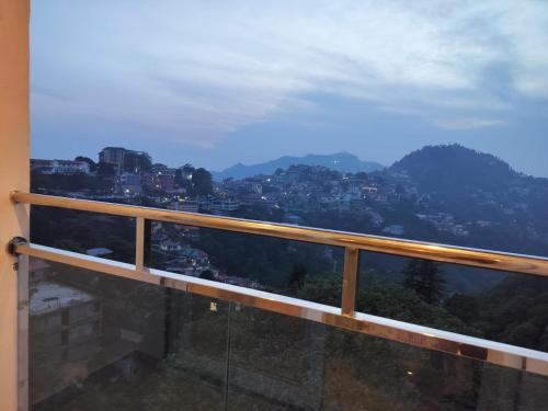 a balcony with a view of a city at Hotel Aaria in Mussoorie