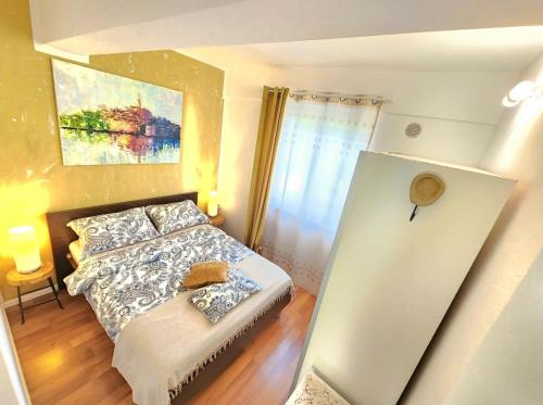 a small bedroom with a bed and a window at Apartment Lucija in Rovinj