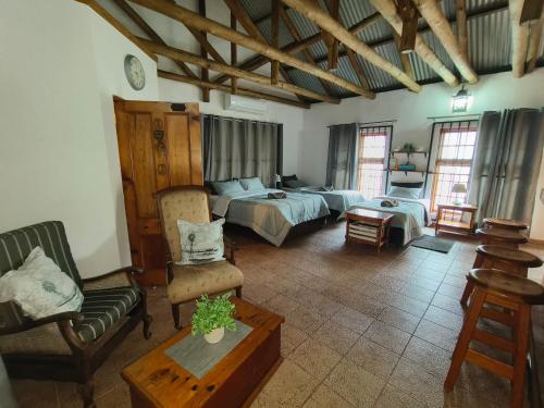 a bedroom with a bed and a couch and a table at Die Oog in Richards Bay