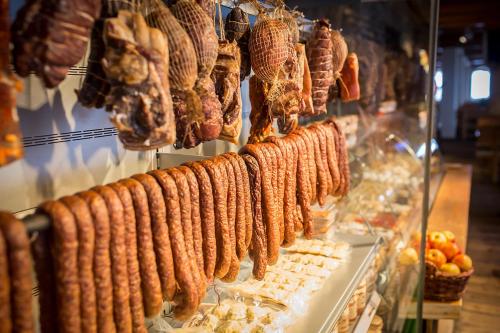 a bunch of sausages hanging in a store at Krakowiacy i Górale in Krzyszkowice