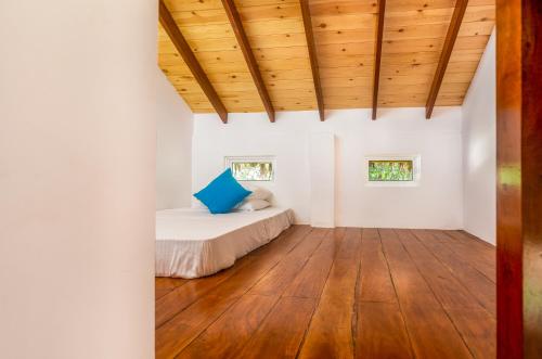 a bedroom with white walls and a wooden ceiling at Tranquil Wild in Tanamalwila