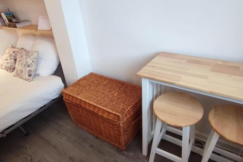 a small room with a bed and a table and stool at Studio-Heart of town-Bd des Pyrenées-Quiet in Pau