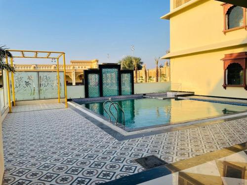 a swimming pool in the middle of a building at Pink Mahal Hotel & Resort in Jaipur