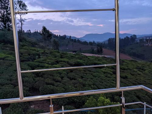 a view from a glass window of a forest at DIAMOND HILL VIEW in Ketti