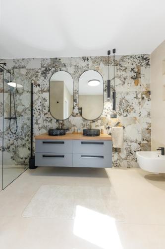 a bathroom with two mirrors and a sink at Luxury Villa My Wish with Pool in Kastel Stari