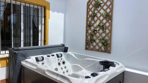 a white bath tub in a room with a window at casa limon in Mazarrón