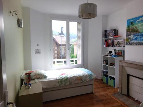 a bedroom with a bed in front of a window at Bamboo villa in Meudon