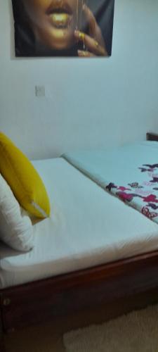 a banana sitting on top of a bed with a picture at Derrian Homes in Eldoret