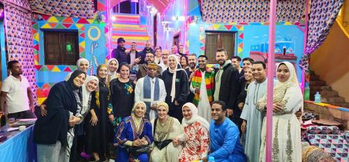 a group of people posing for a picture in a room at Opal privat nubian hotel in Aswan