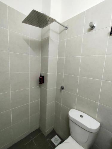 a bathroom with a toilet and a shower at FIRASH HOMESTAY AT SERI ISKANDAR in Seri Iskandar