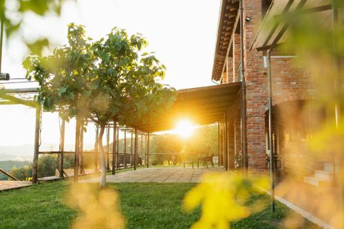 a house with a view of a patio with trees at Agriturismo La Burlanda in Fosdinovo