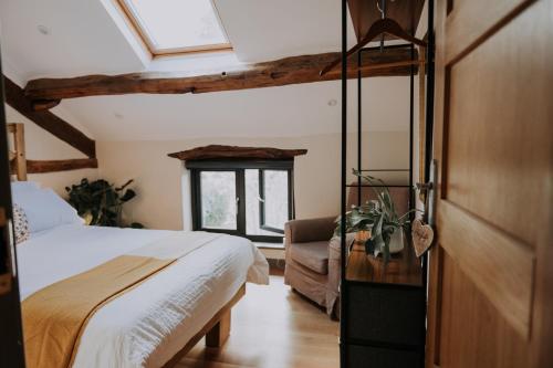 a bedroom with a bed and a couch and a window at High House Barn in Bassenthwaite